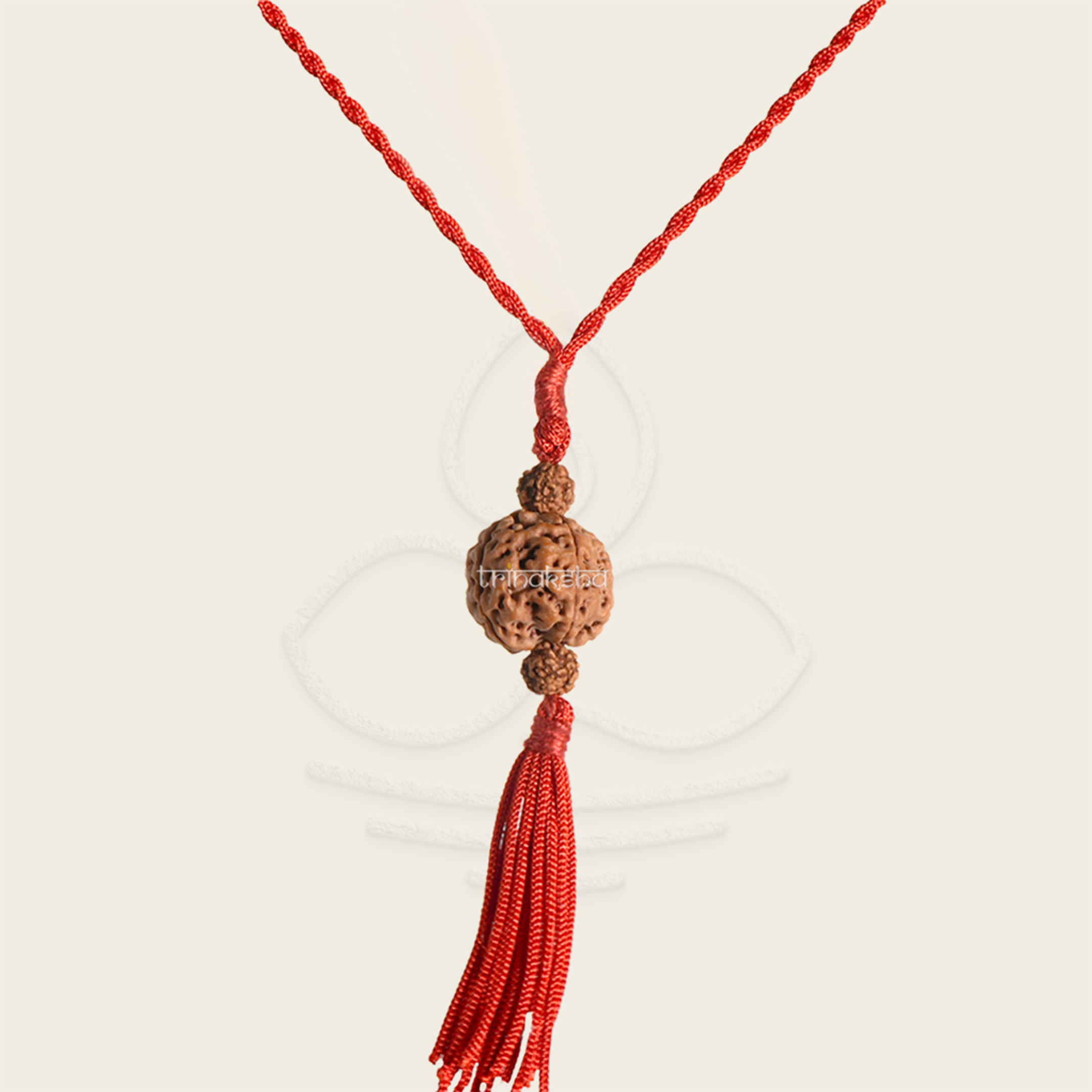 Brown five-faced Rudraksha bead pendant with red braided cord and tassel, spiritual meditation accessory.